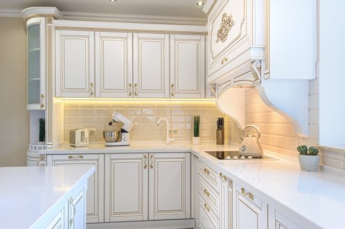 White custom kitchen cabinetry with under-cabinet lighting